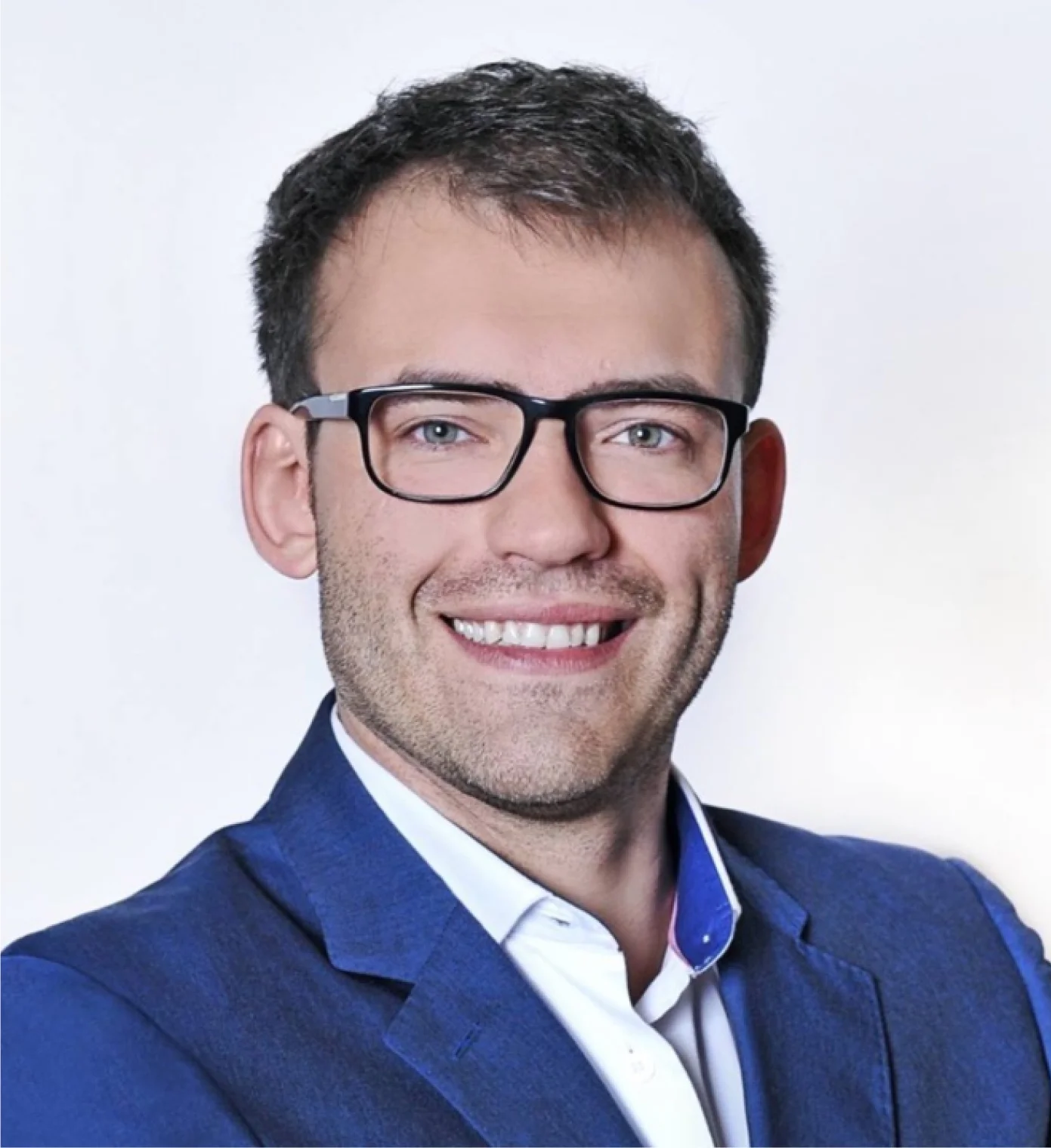 Smiling guy with glasses with black frames and blond hair